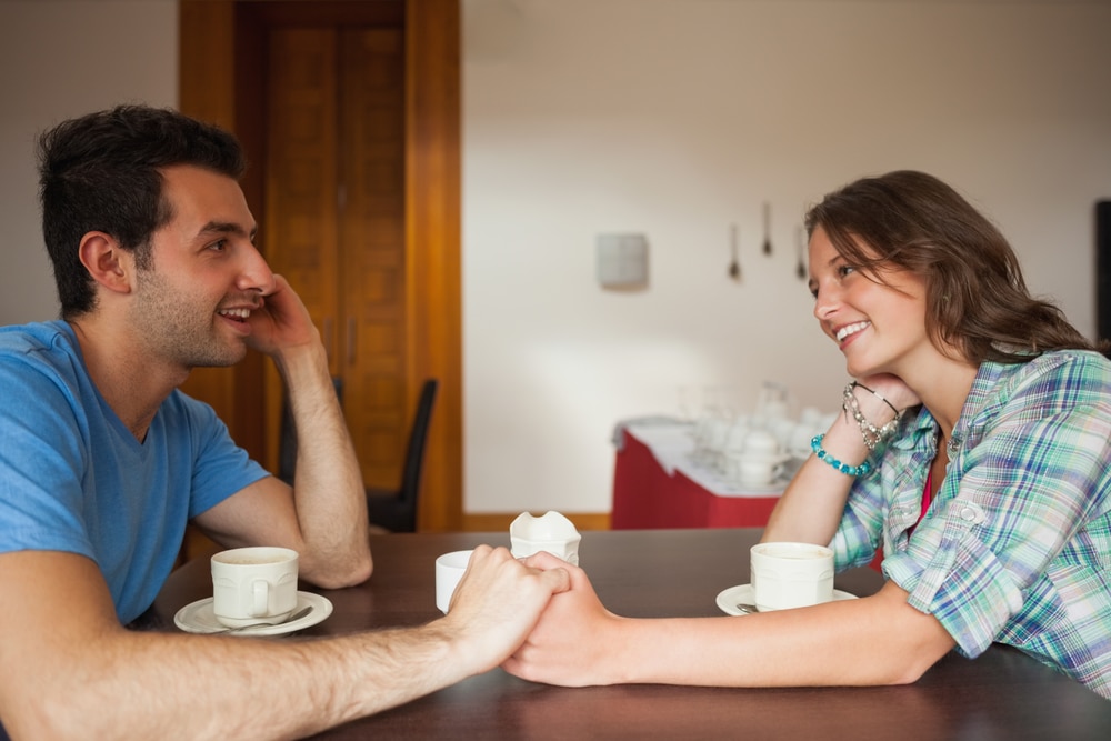 Couple holding hands while talking