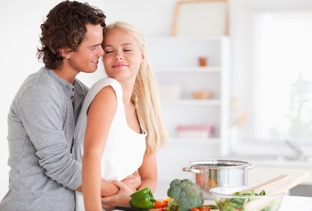 Couple hugging while cooking