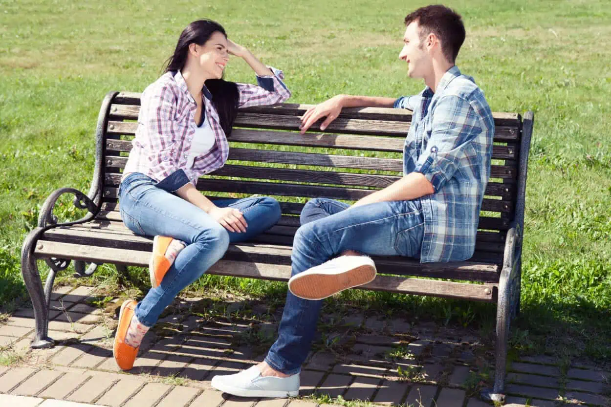 Couple sitting on a bench talking