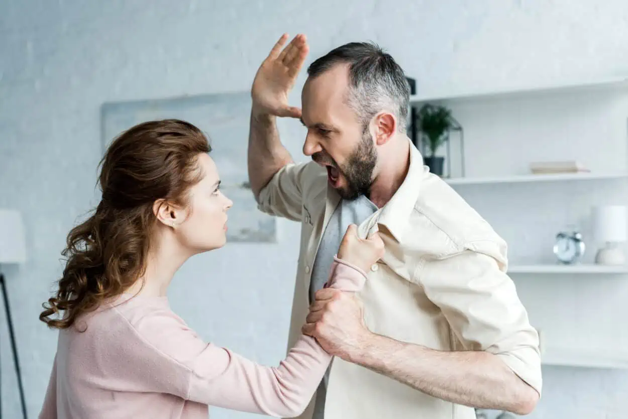 Abusive husband about to slap wife