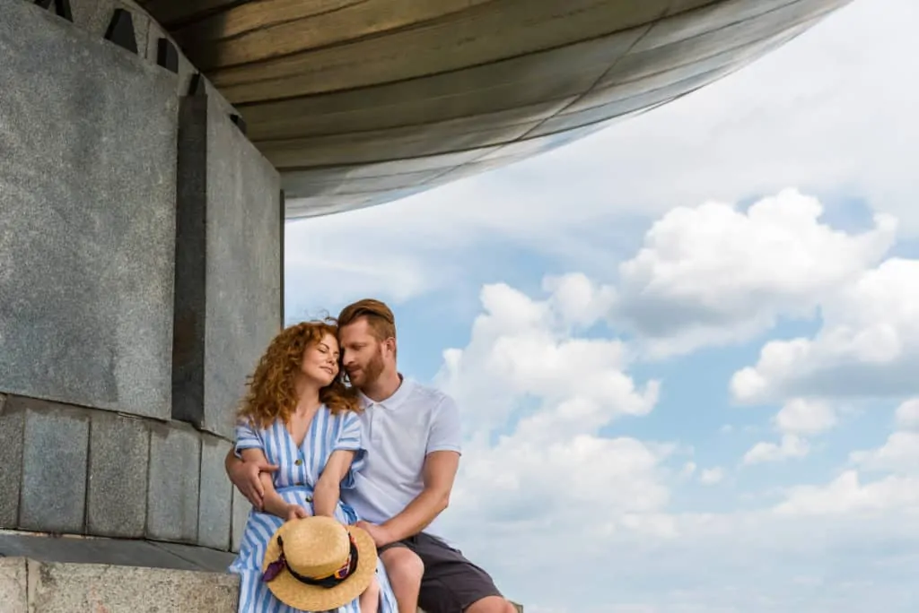 Blue Skies Couple Sitting On A Building