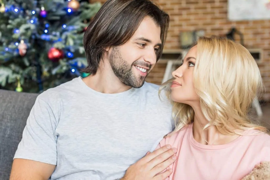Couple At Home With A Christmas Tree
