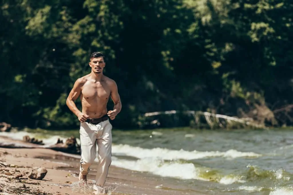 Man Jogging By The Shore