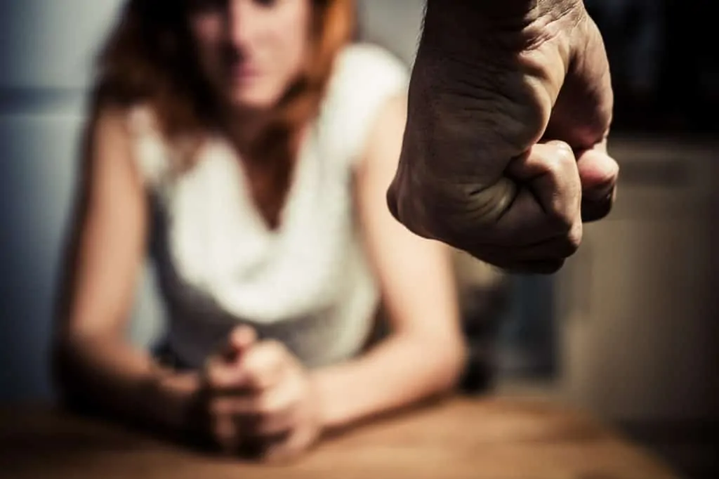 Mans Fist With Woman In The Background