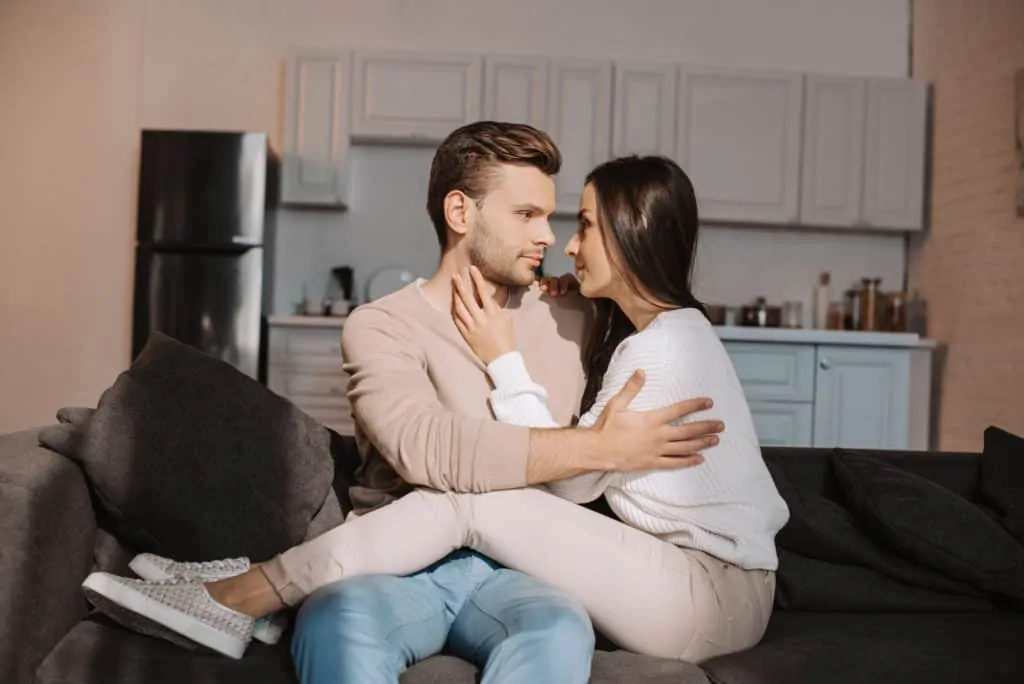 Woman On Boyfriends Lap Looking At Each Other