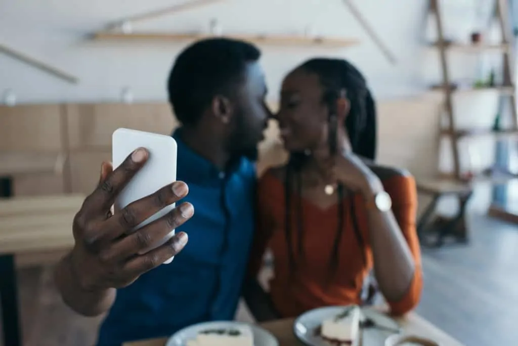 Couple Taking A Selfie While Kissing