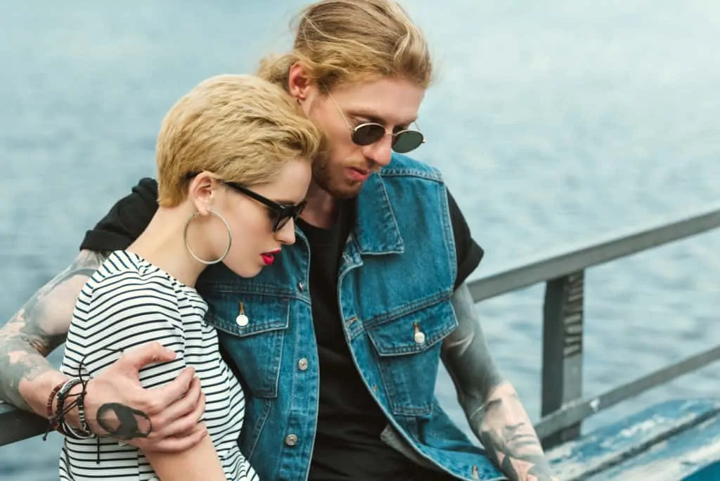 Couple Wearing Sunglasses By The Port