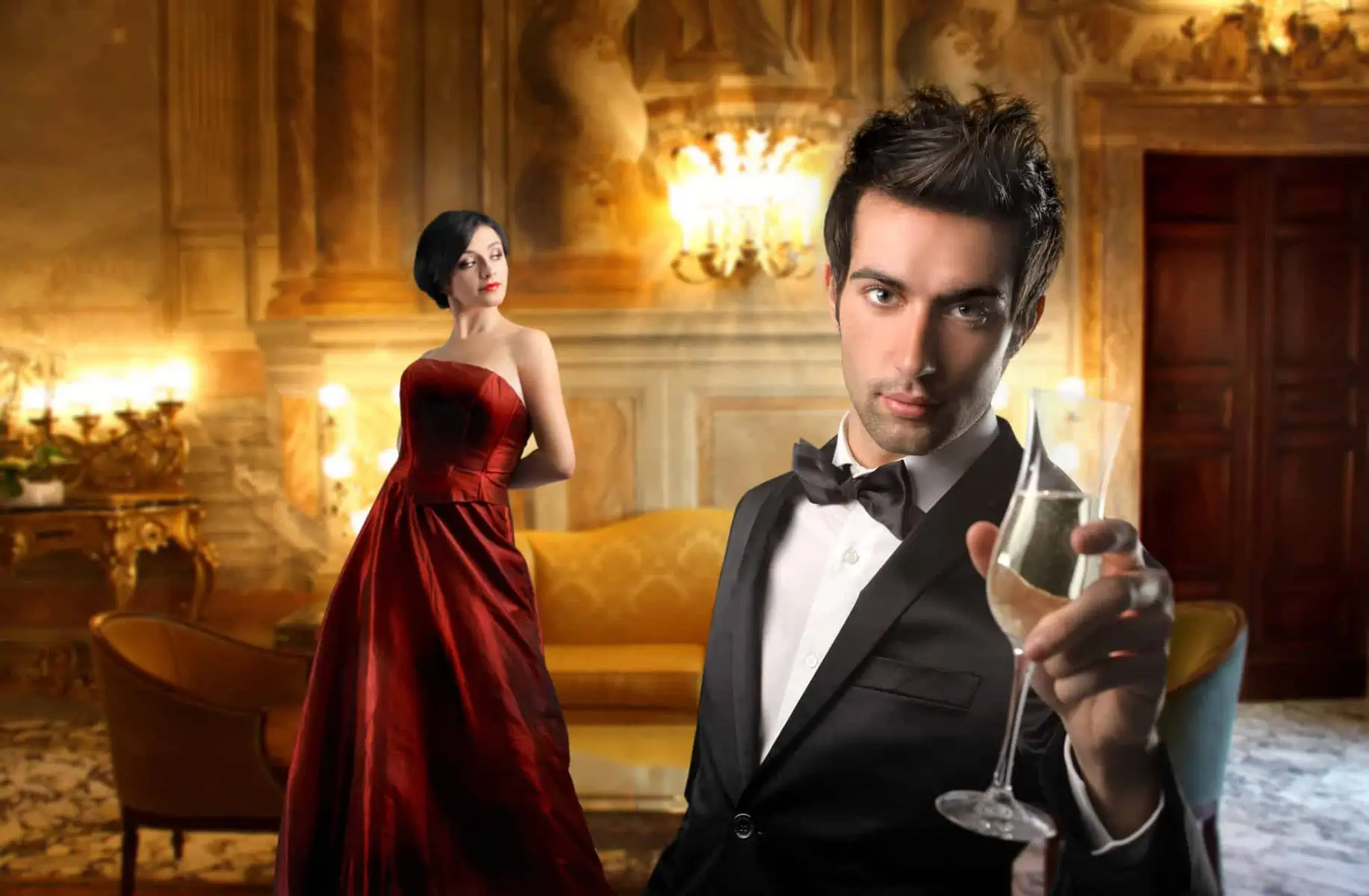 A man in a tuxedo holding a wine glass