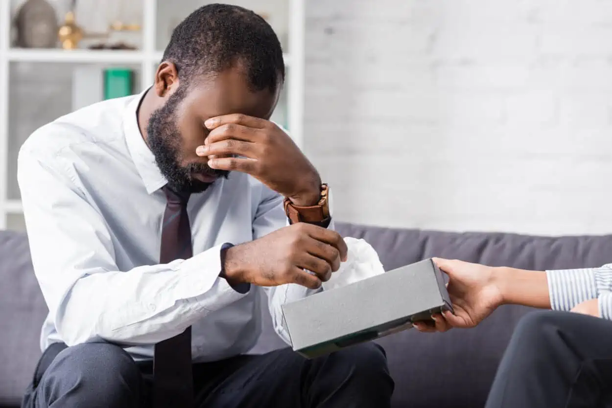 Crying man pulling a tissue