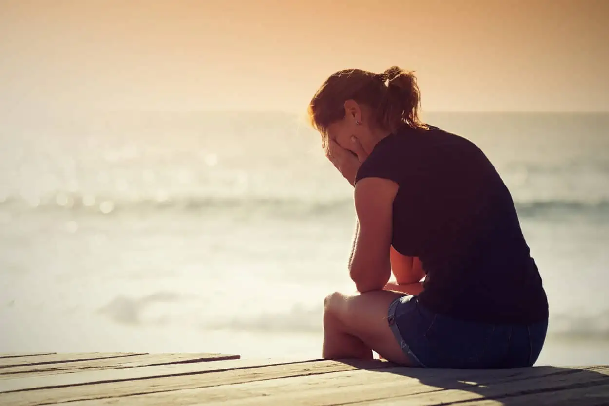 Sad woman by the beach