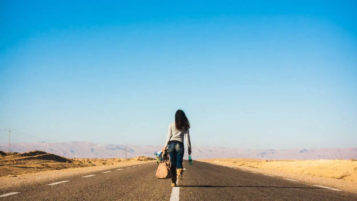 Woman on a road walking away