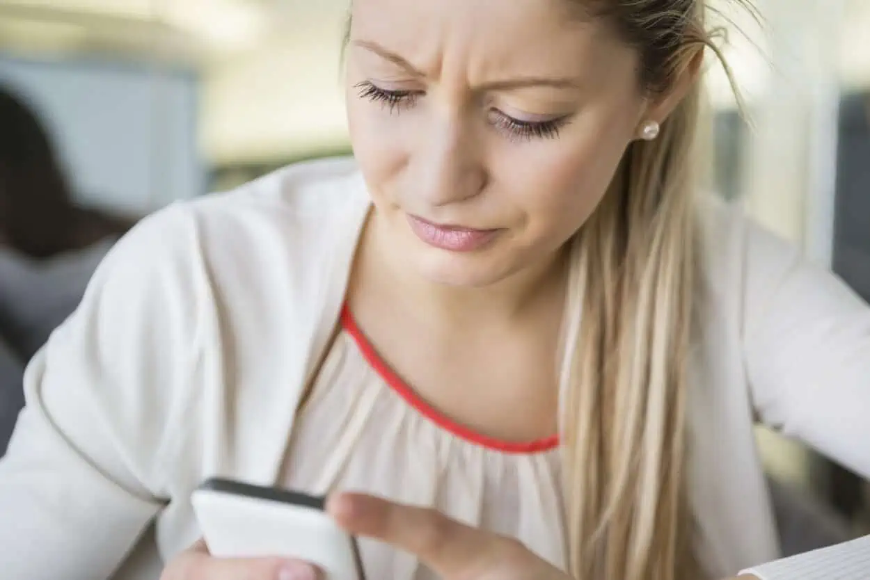 Angry woman looking at her phone