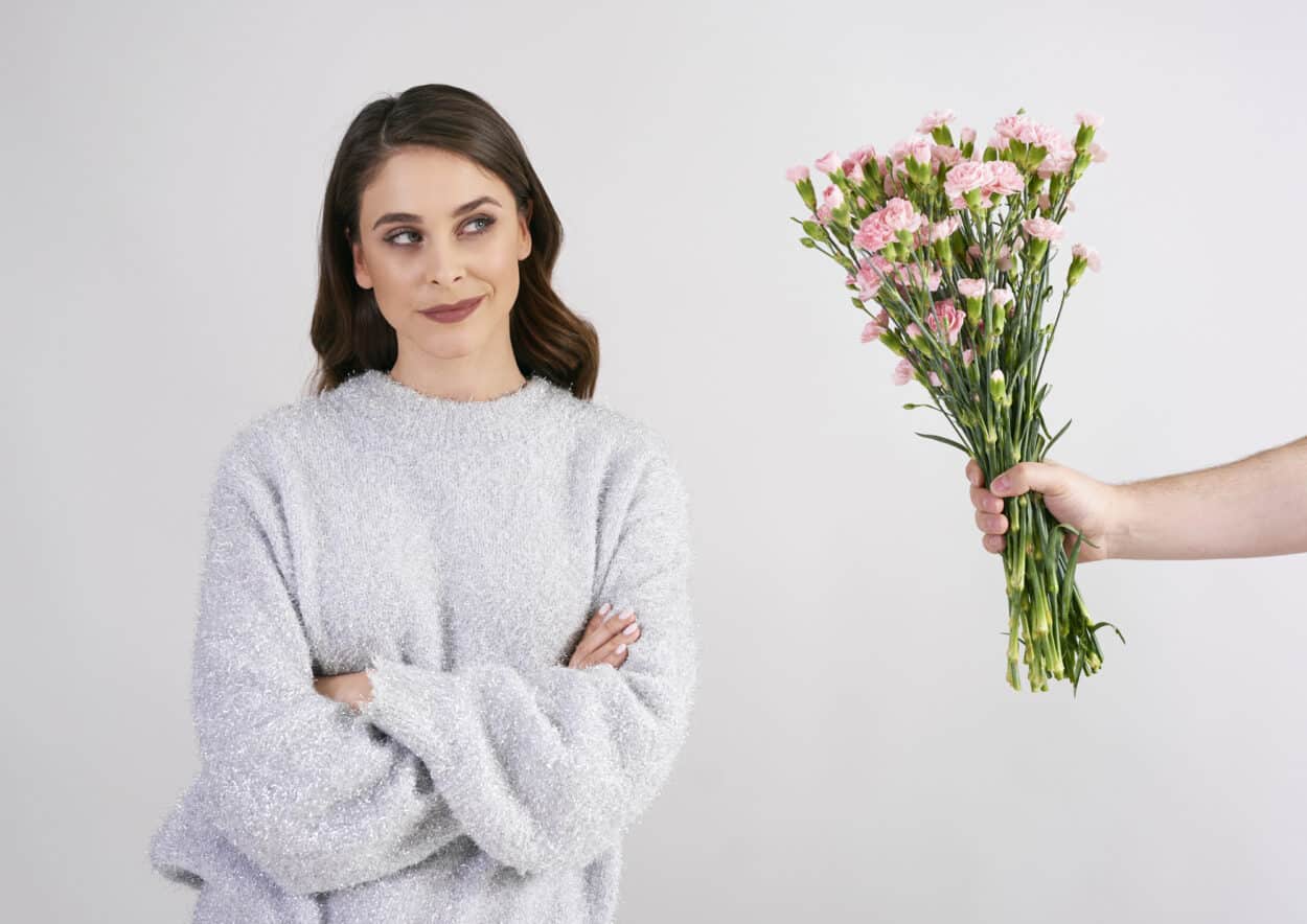 Someone giving flowers to a woman