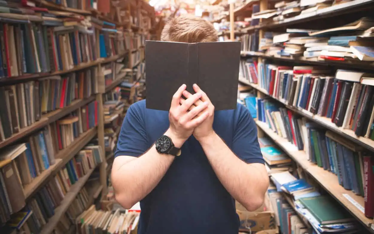 Man hiding with a book on his face