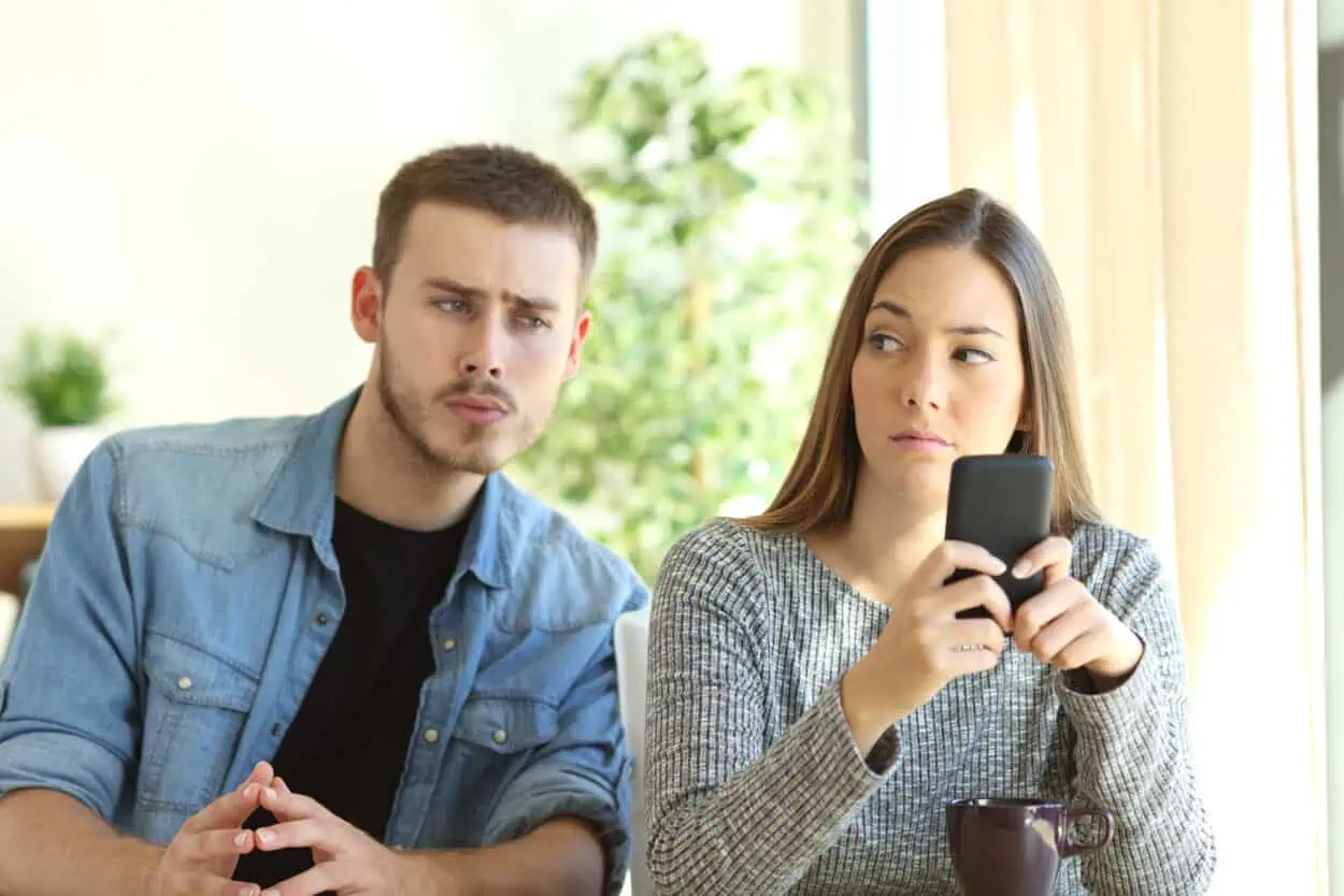 Man peeking on to a woman's phone
