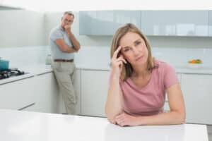 Woman ignoring a man in the kitchen