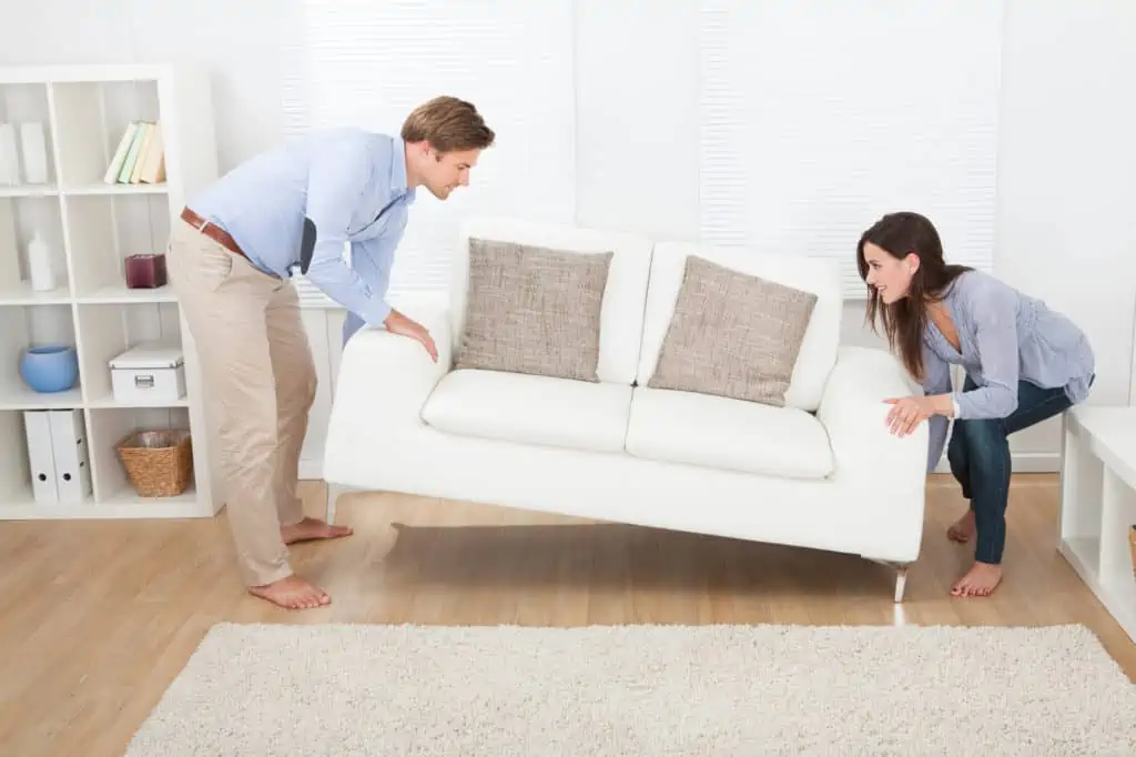 Couples lifting a sofa