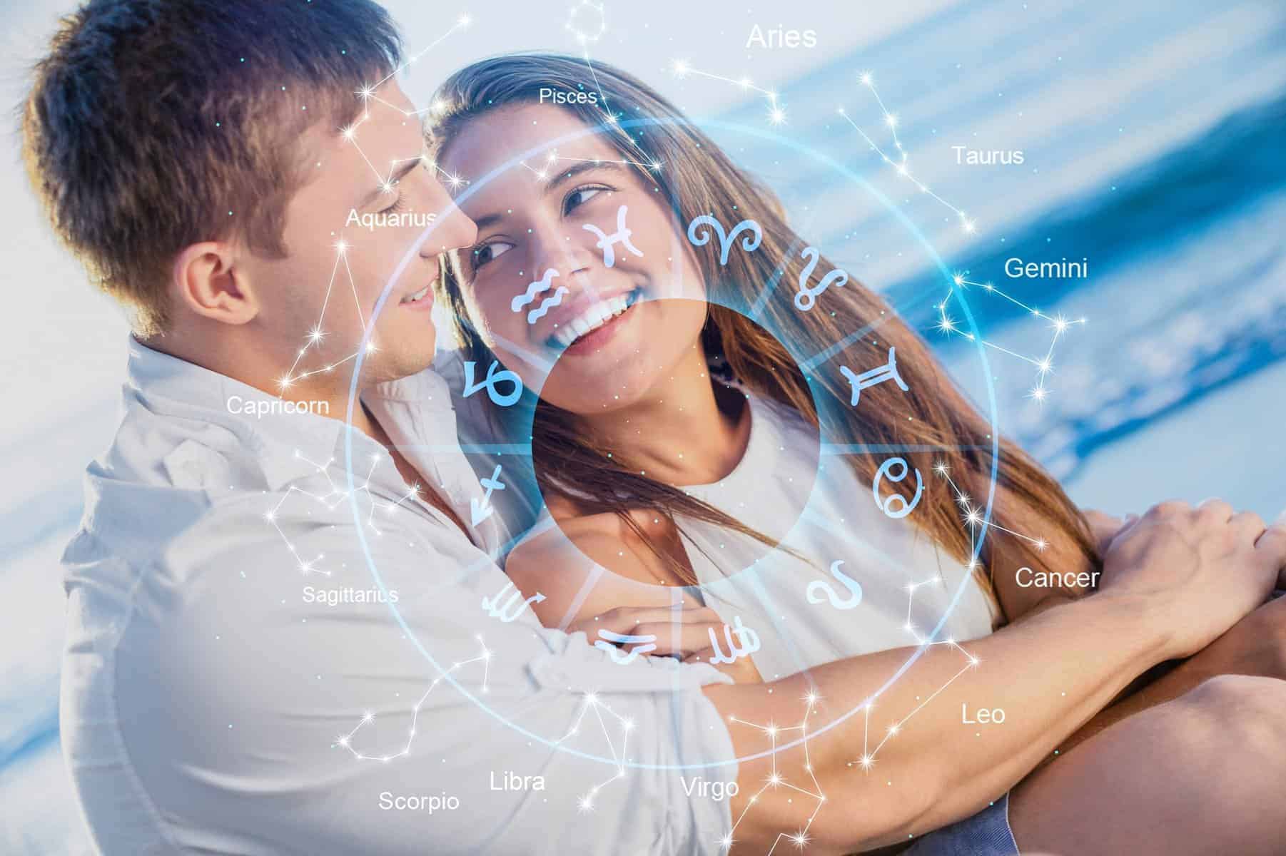 A man and a woman embracing each other in front of zodiac signs