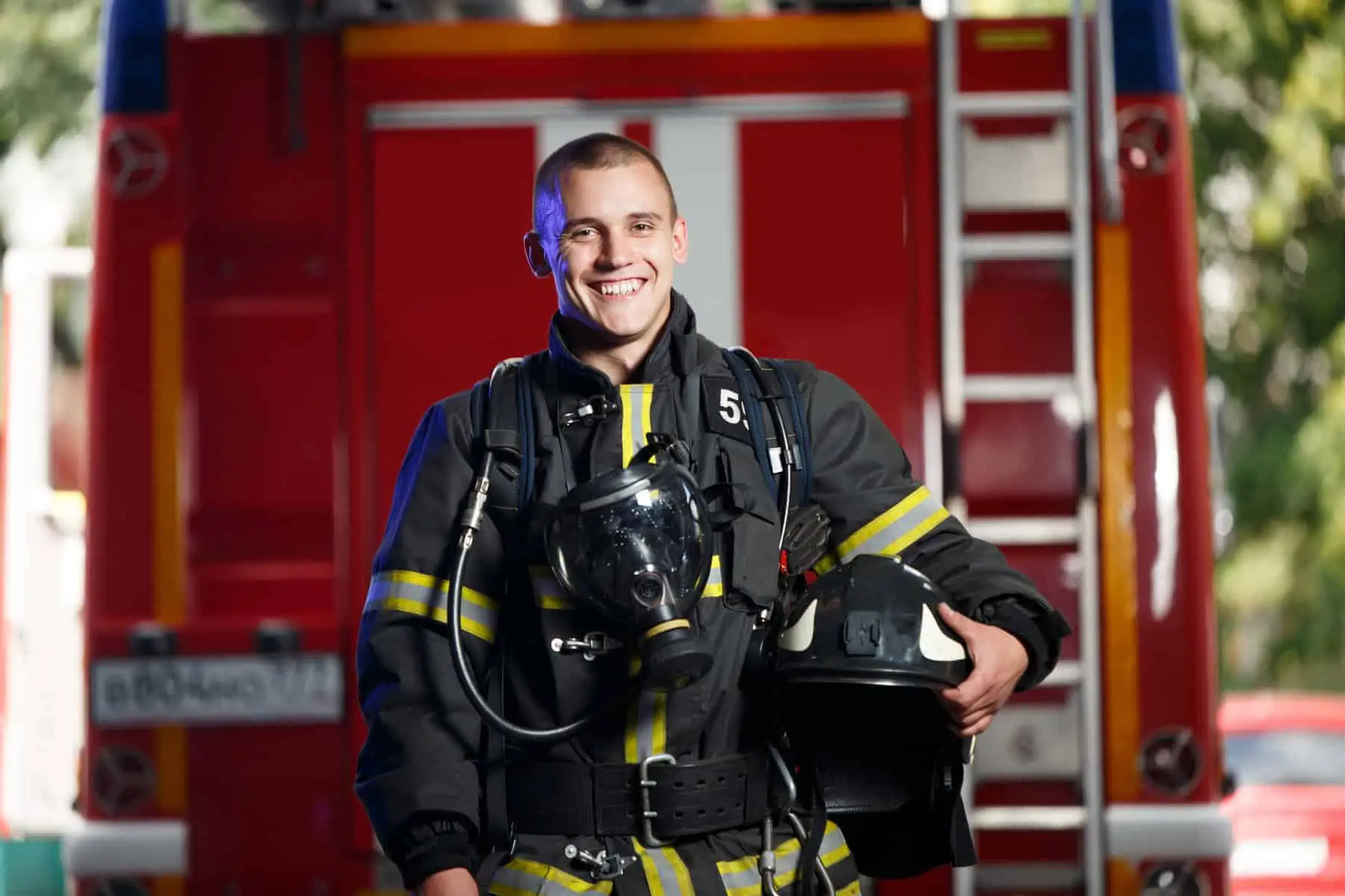 A firefighter standing in front of a fire truck