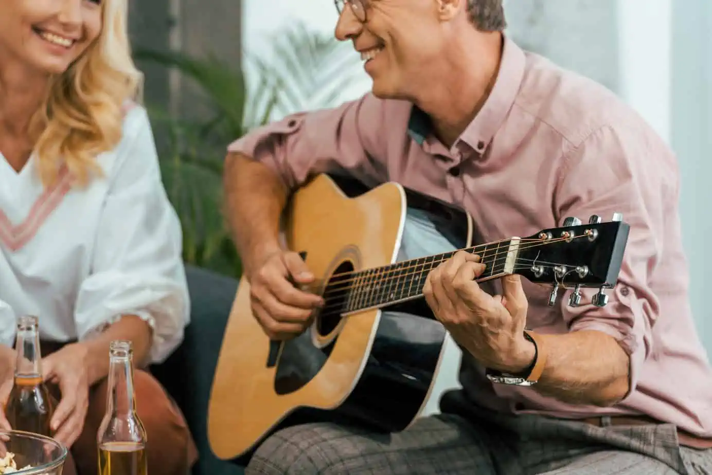 A man playing a guitar next to a woman