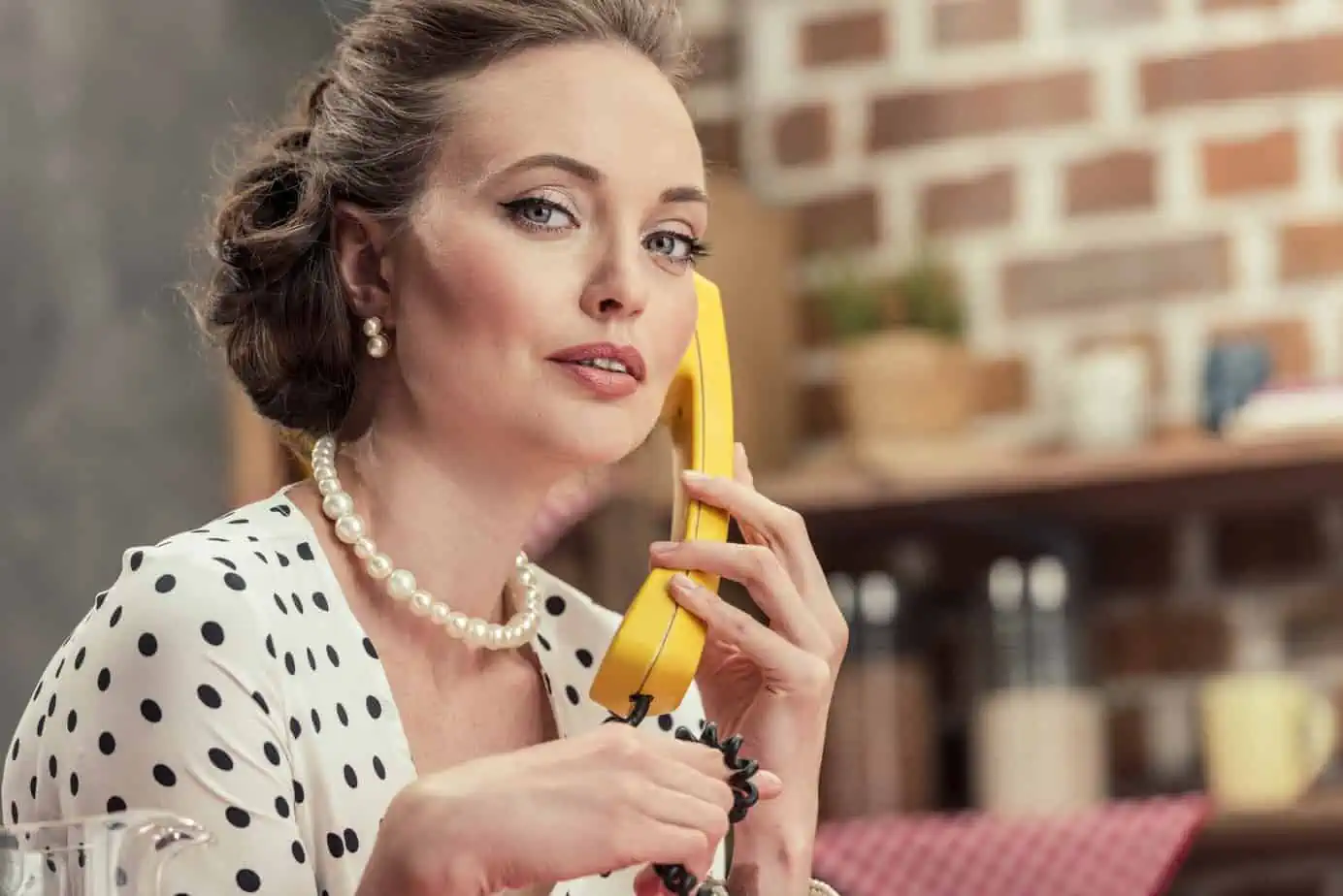 A woman holding a banana up to her face