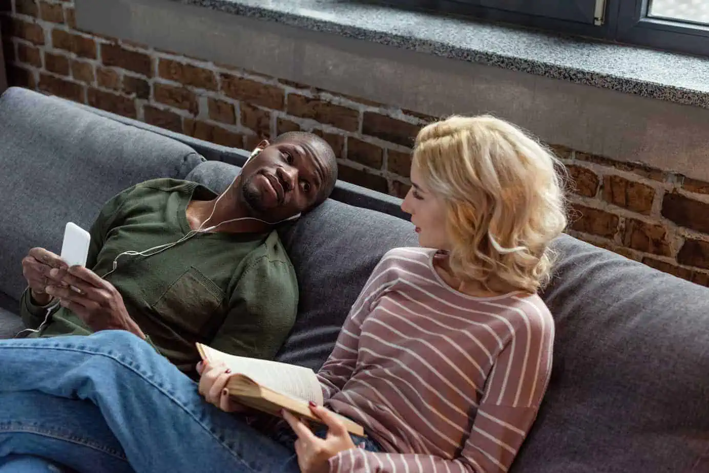 A man and a woman sitting on a couch