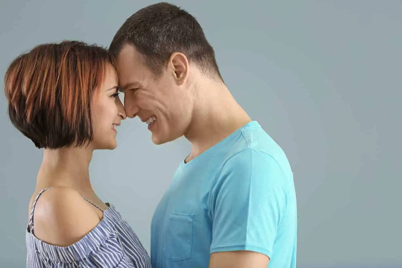 A man and a woman smiling at each other