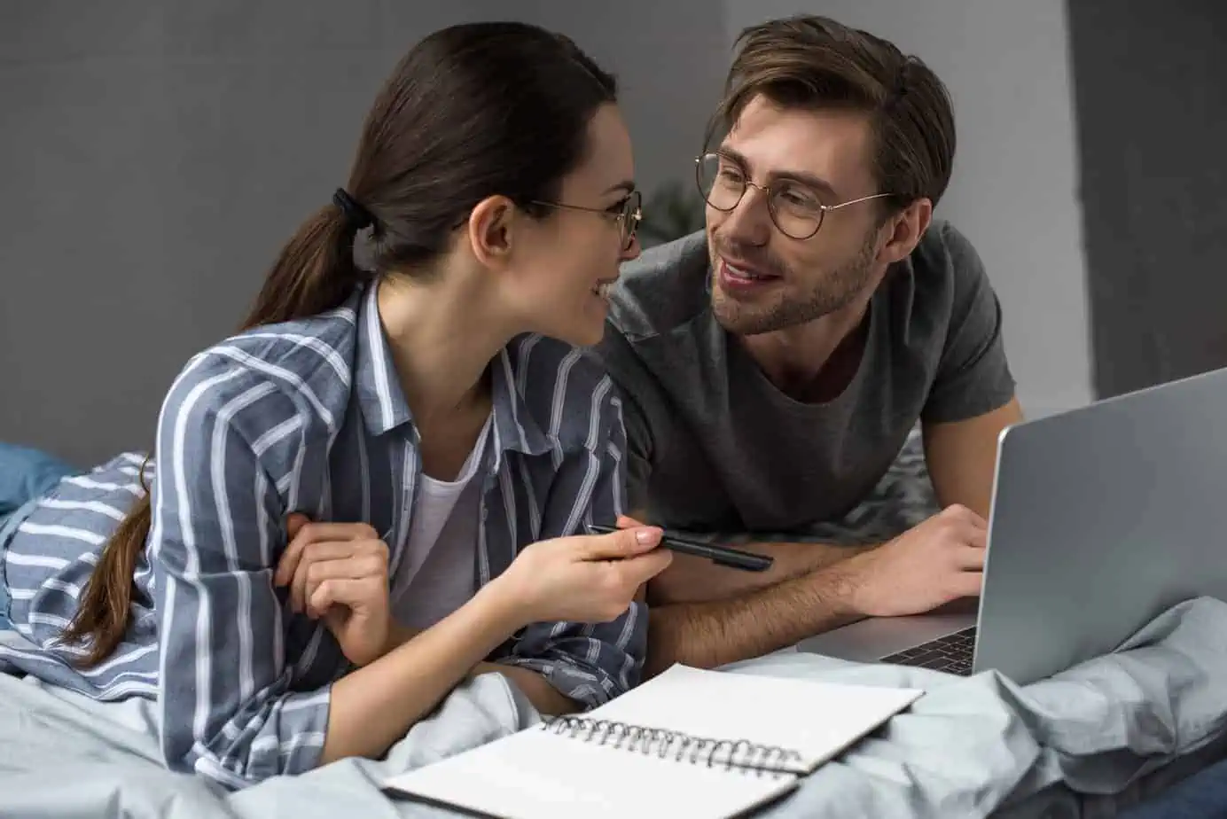 A man and a woman looking at a laptop