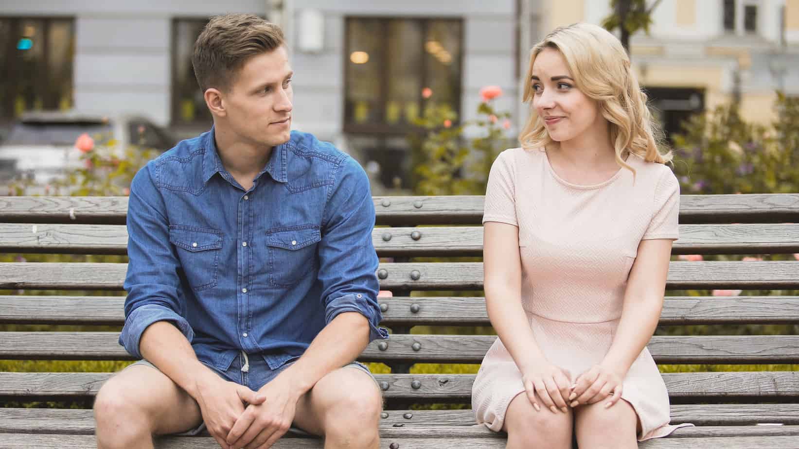 A man and a woman sitting on a bench