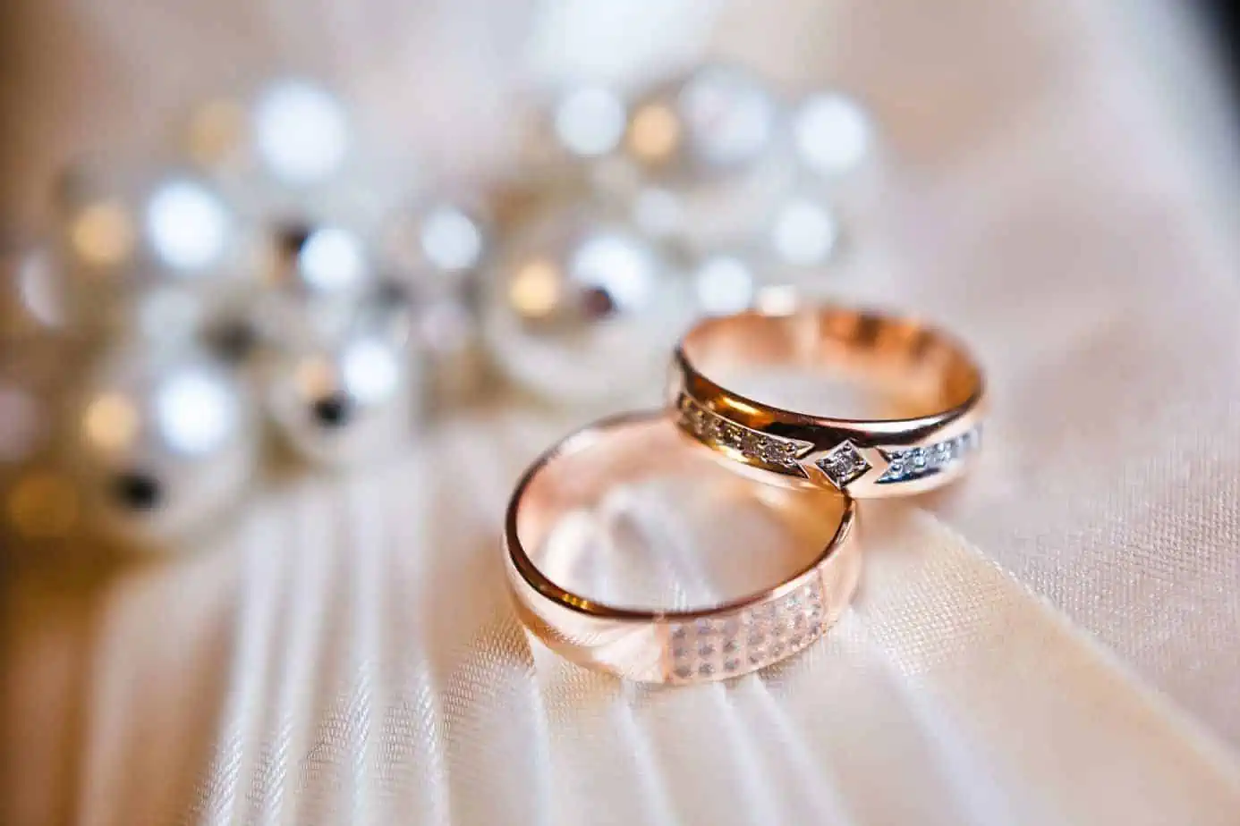 Two wedding rings sitting on top of a table