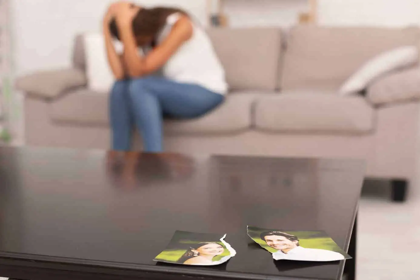 A woman sitting on a couch in front of a coffee table
