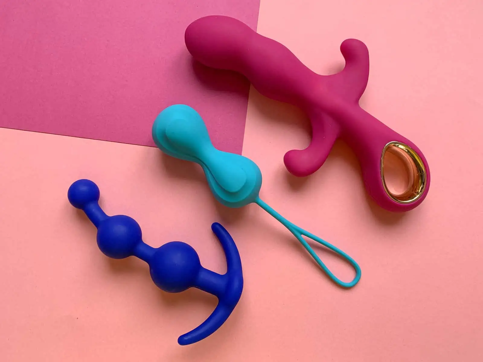 A pair of scissors and a fake mustache on a pink and blue background