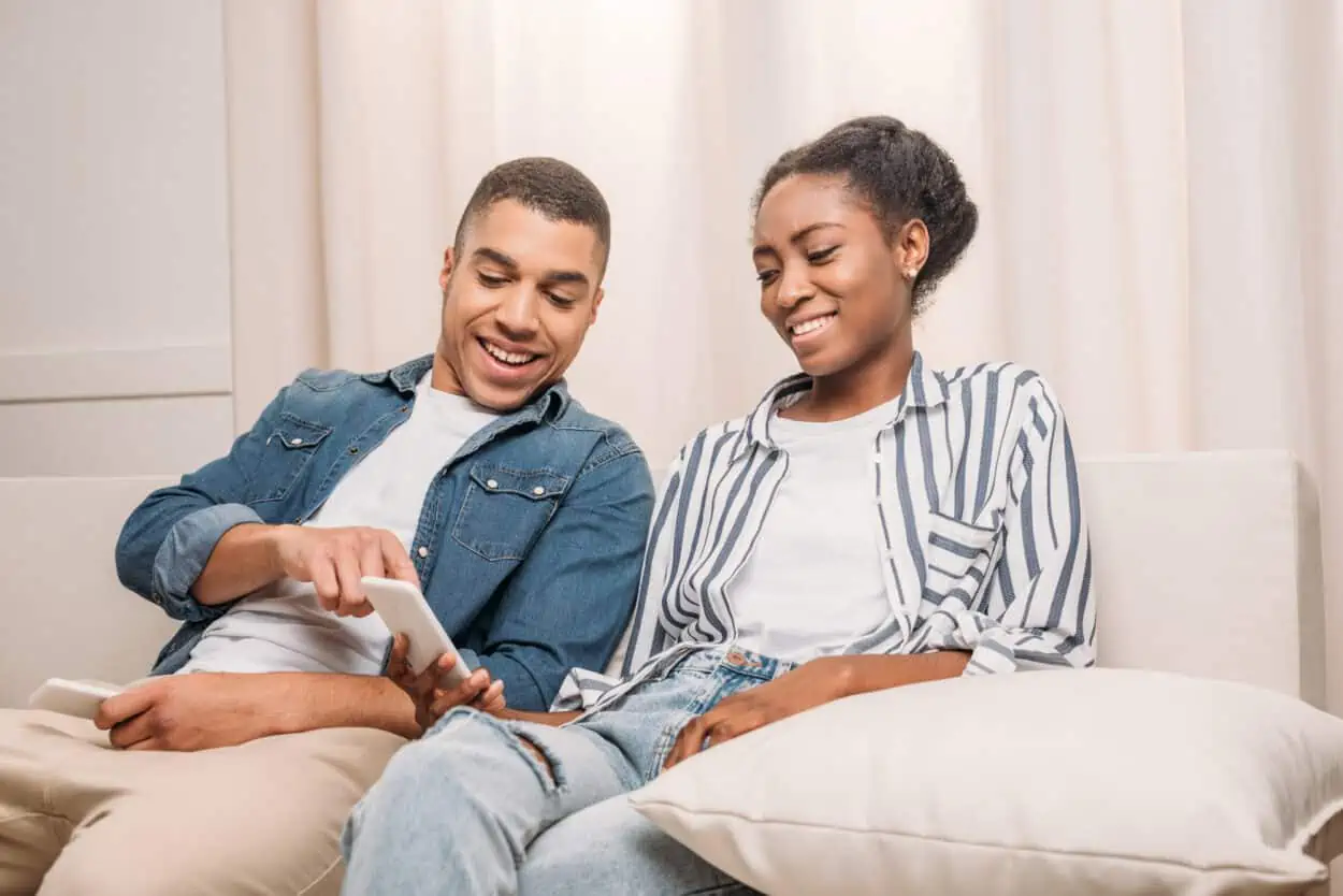 Happy Couples Looking at a Mobile Phone