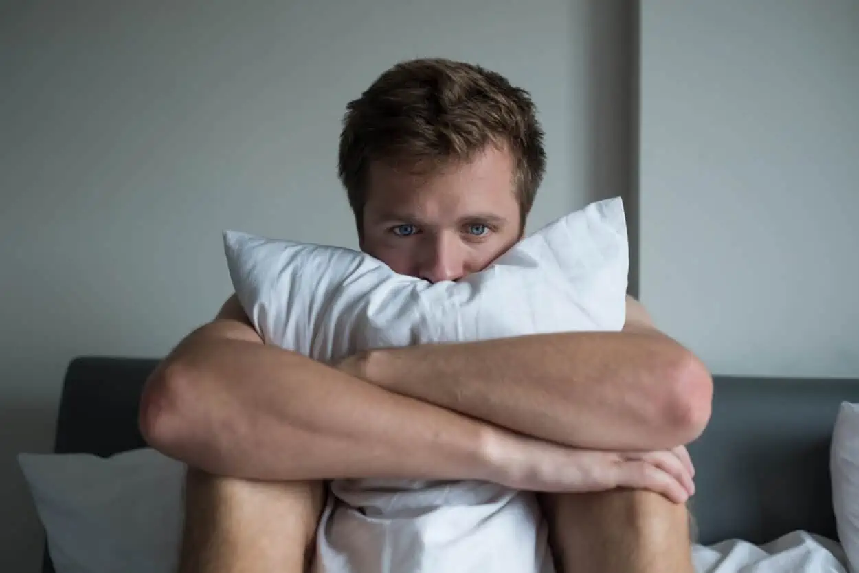 Man hugging a pillow