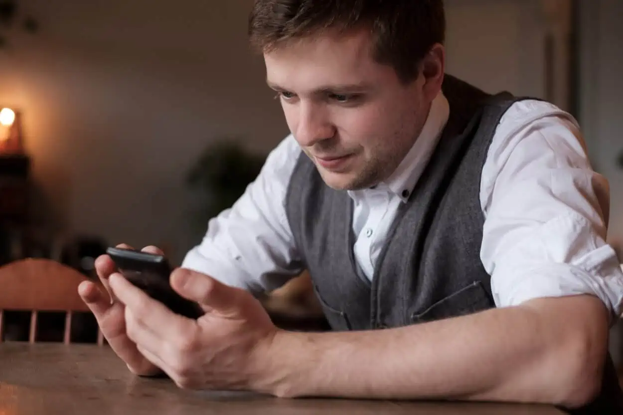 Man smiling and texting