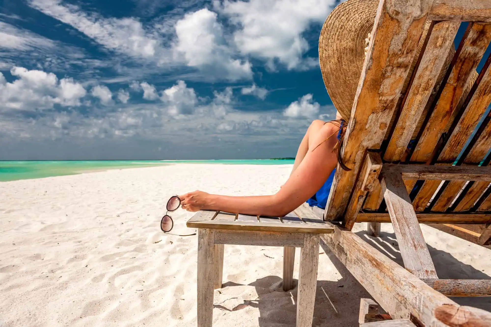 A woman sitting in a chair on a beach