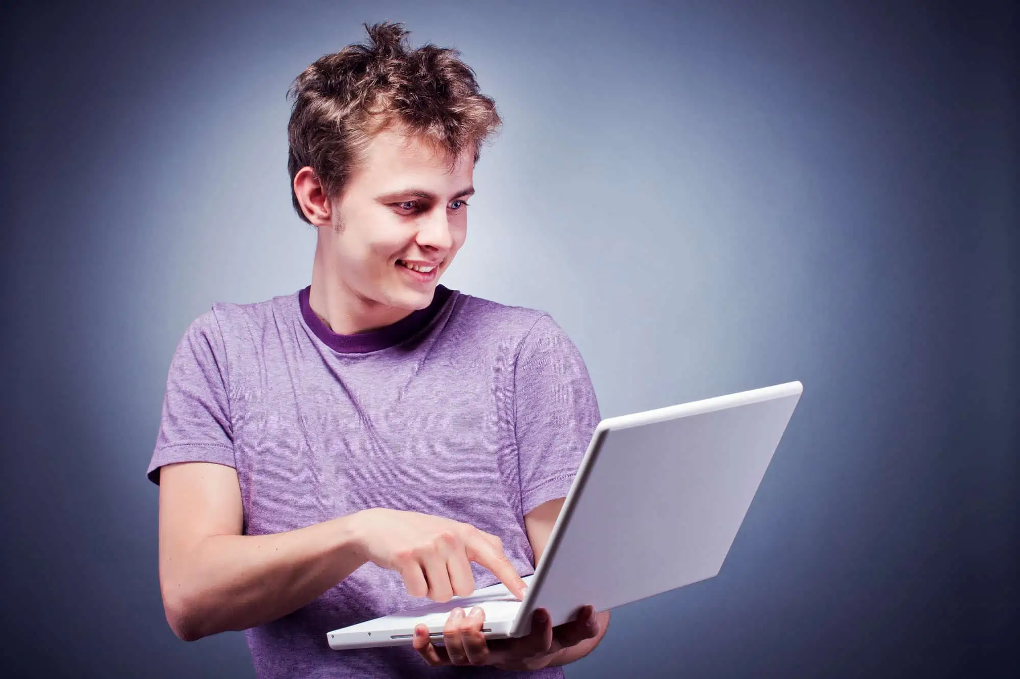 A young man is using a laptop computer