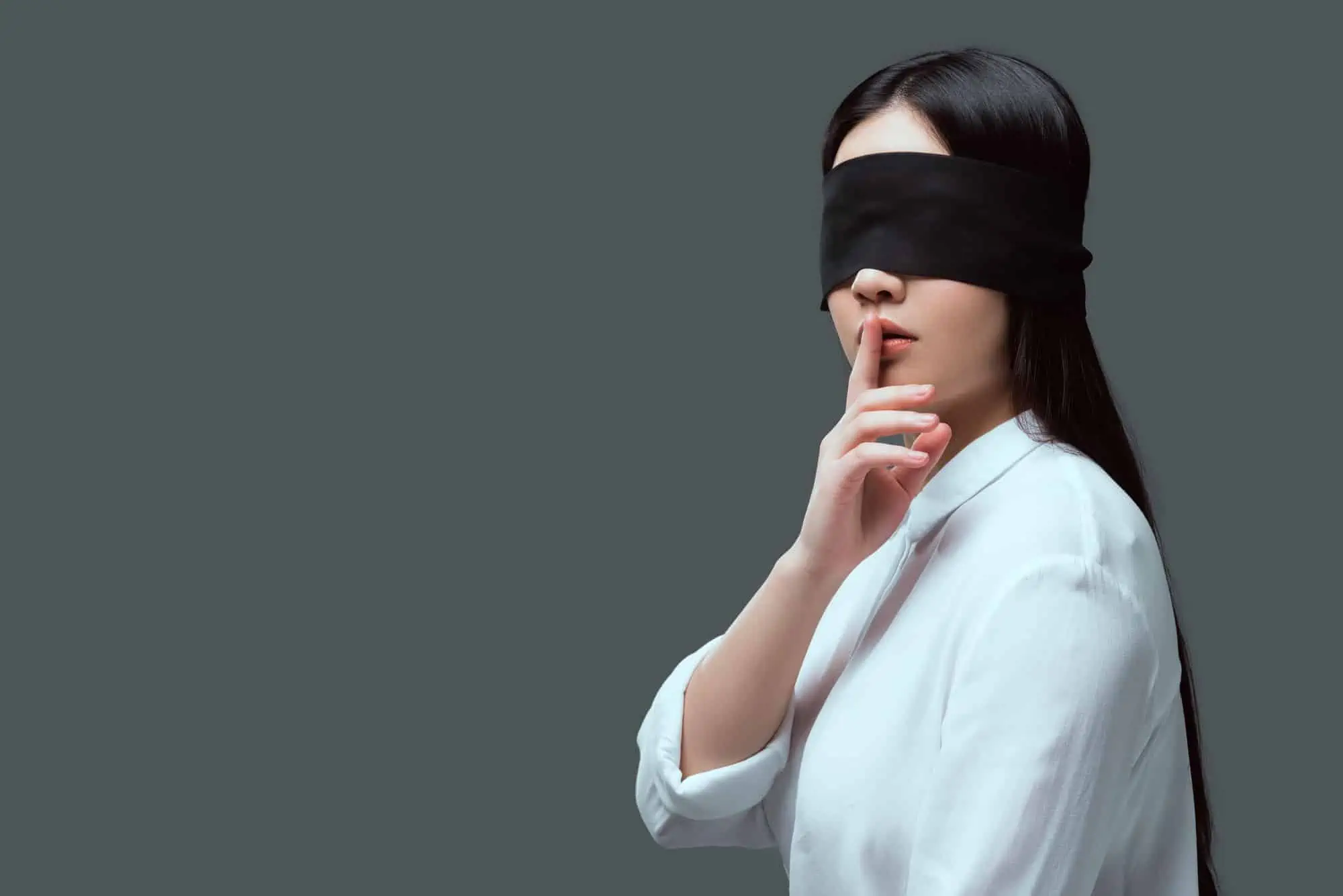 A woman with a blindfold on her face