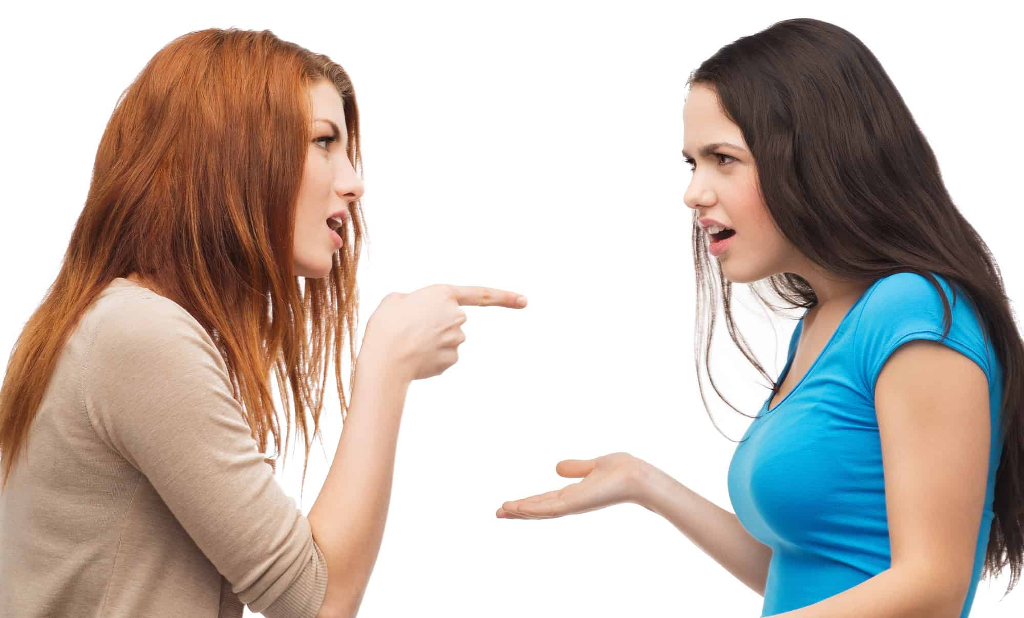 Two women pointing at each other with their hands