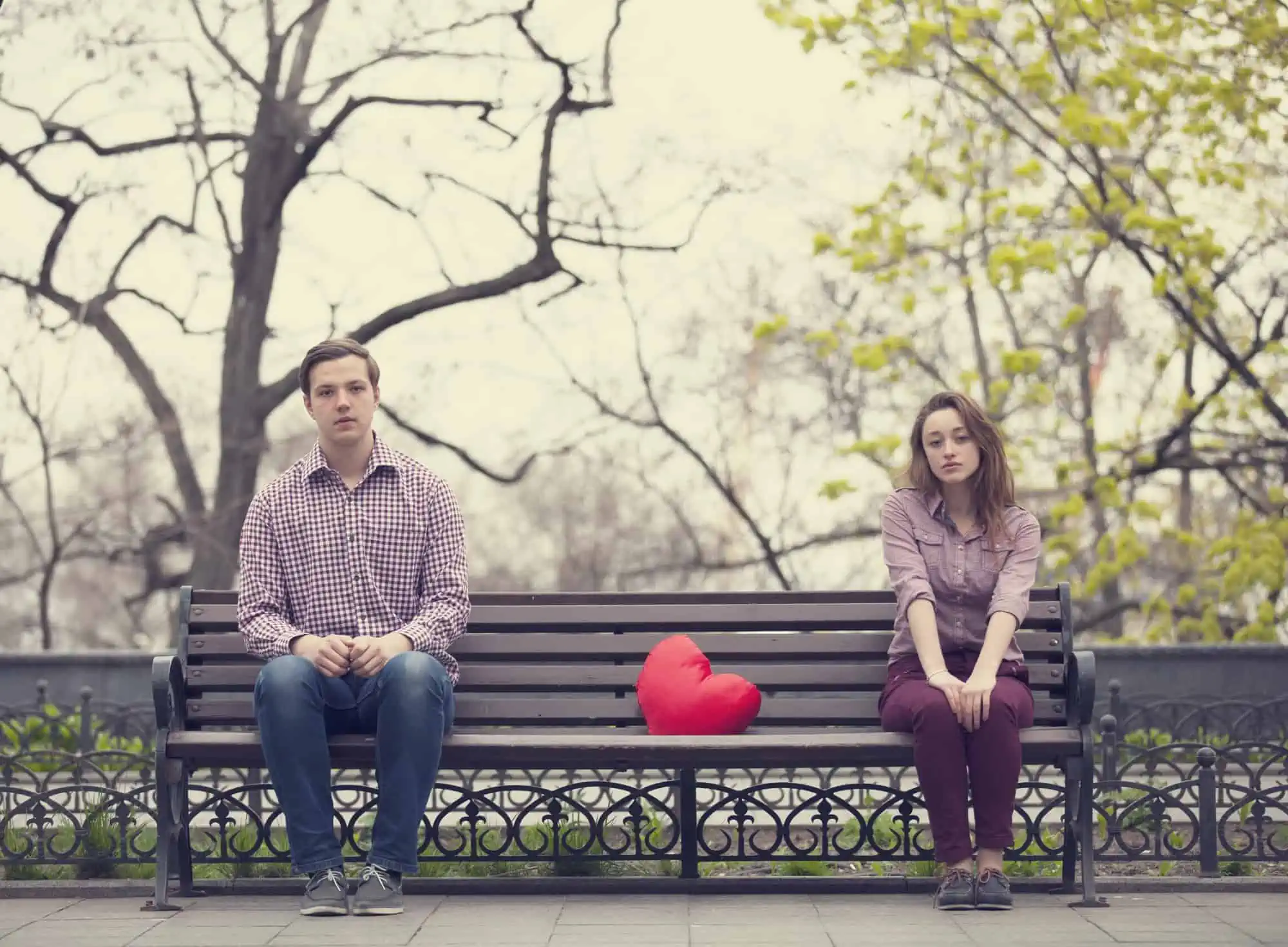 A man and a woman sitting on a bench
