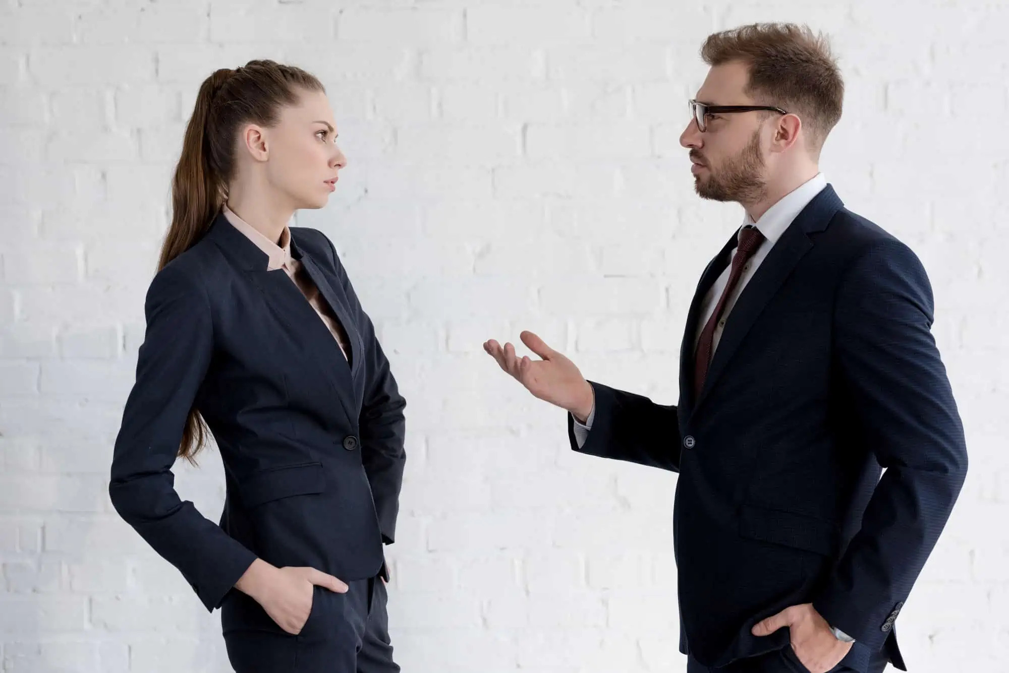 A man and a woman in business attire talking to each other