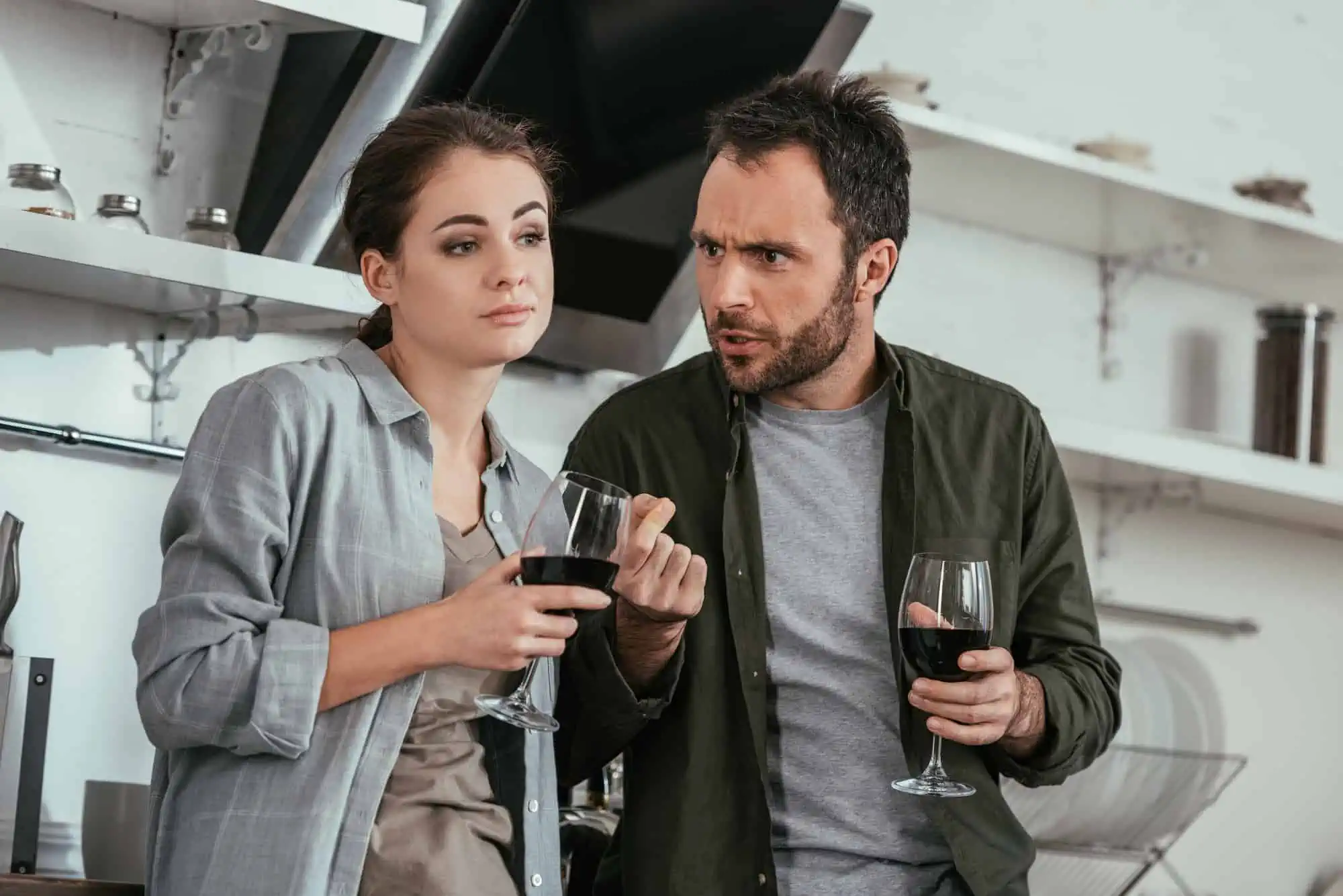 A man and a woman holding wine glasses
