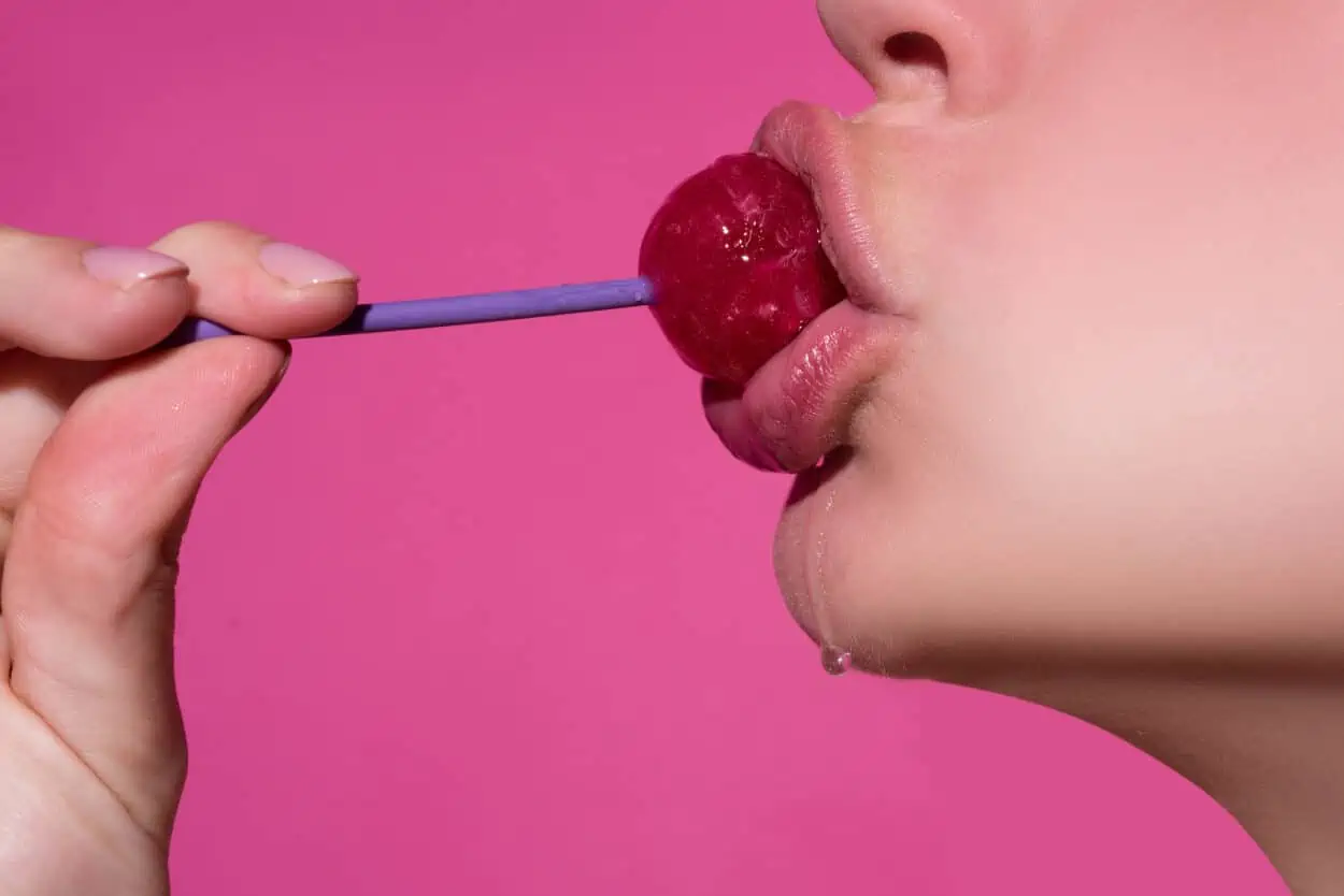 Woman kissing a lollipop