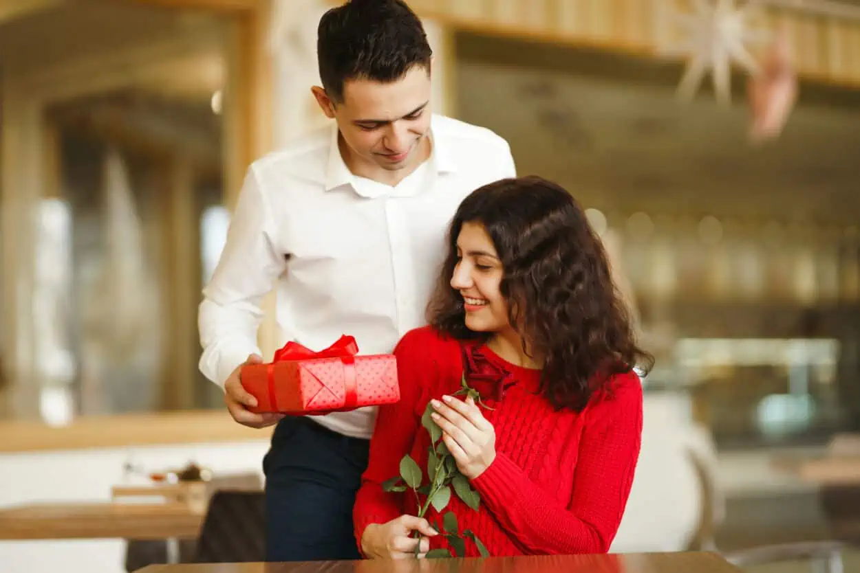 Man giving a gift to his date